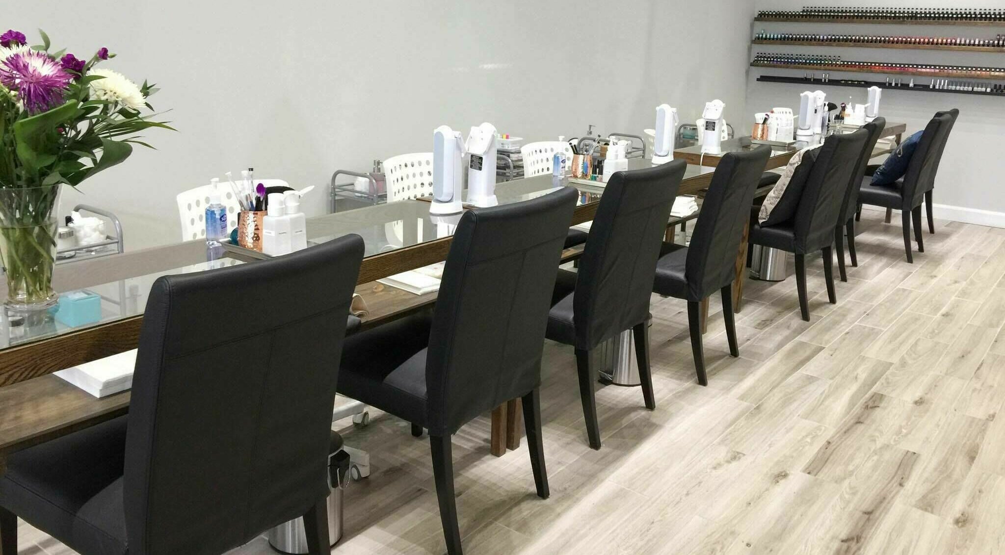 Chic manicure stations at Luna Nails and Spa, Ottawa, Ontario, CA, with flowers and modern decor.