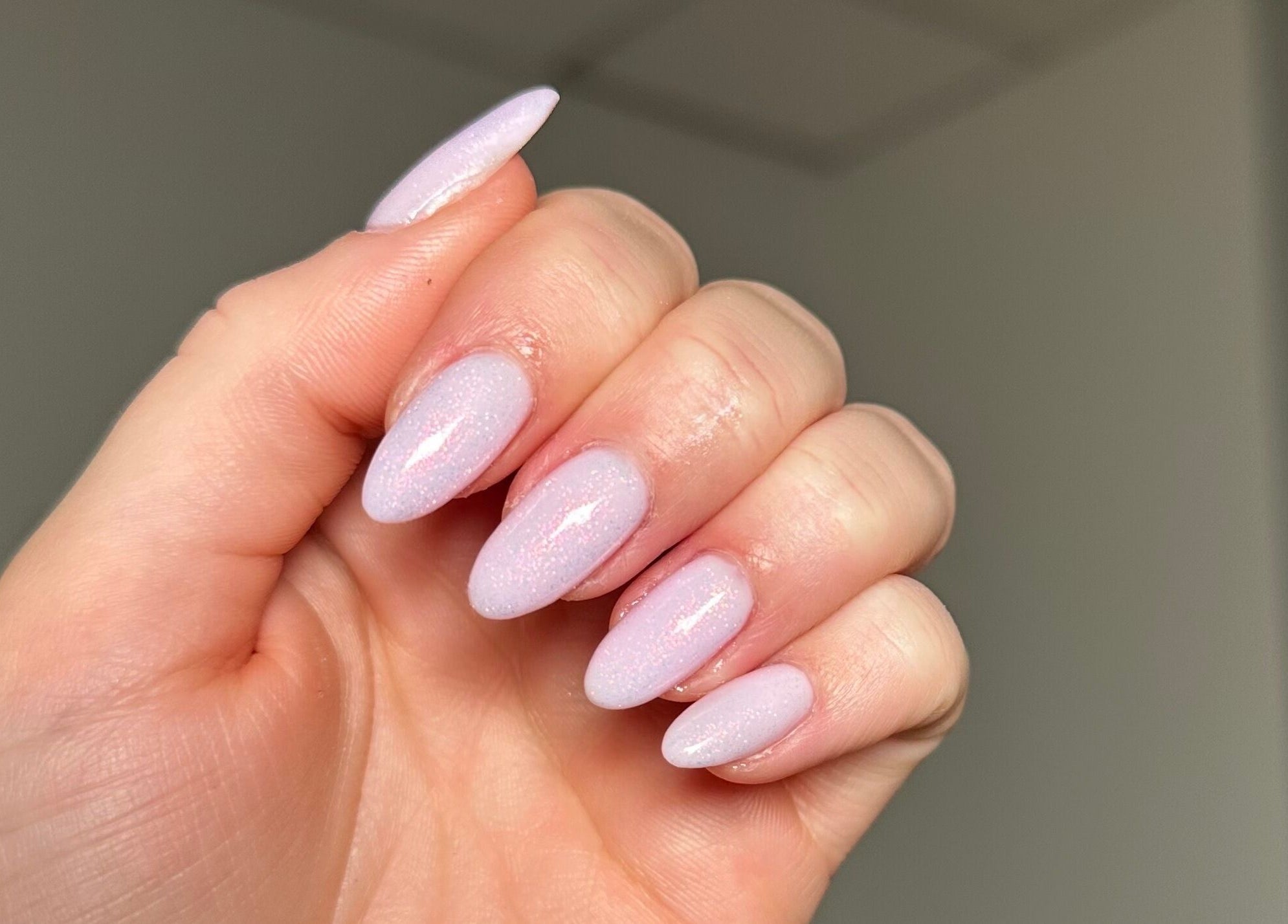 Stylish manicured nails at By Melissa Studio, East Kilbride, Scotland, GB. Soft pink glitter finish.