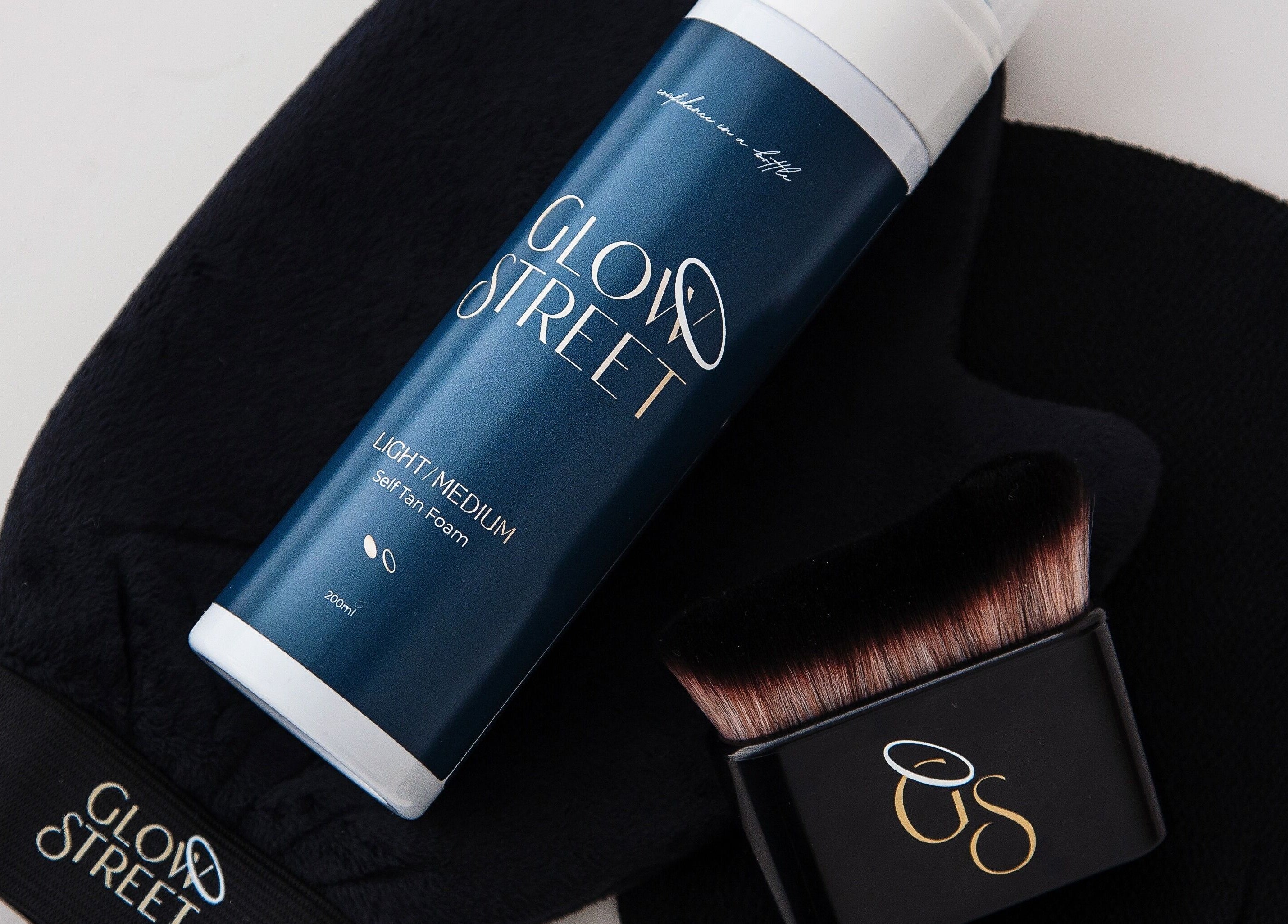 Self-tan products from Inner Glow Beauty, Bulls, Manawatū-whanganui, NZ displayed with a black applicator.