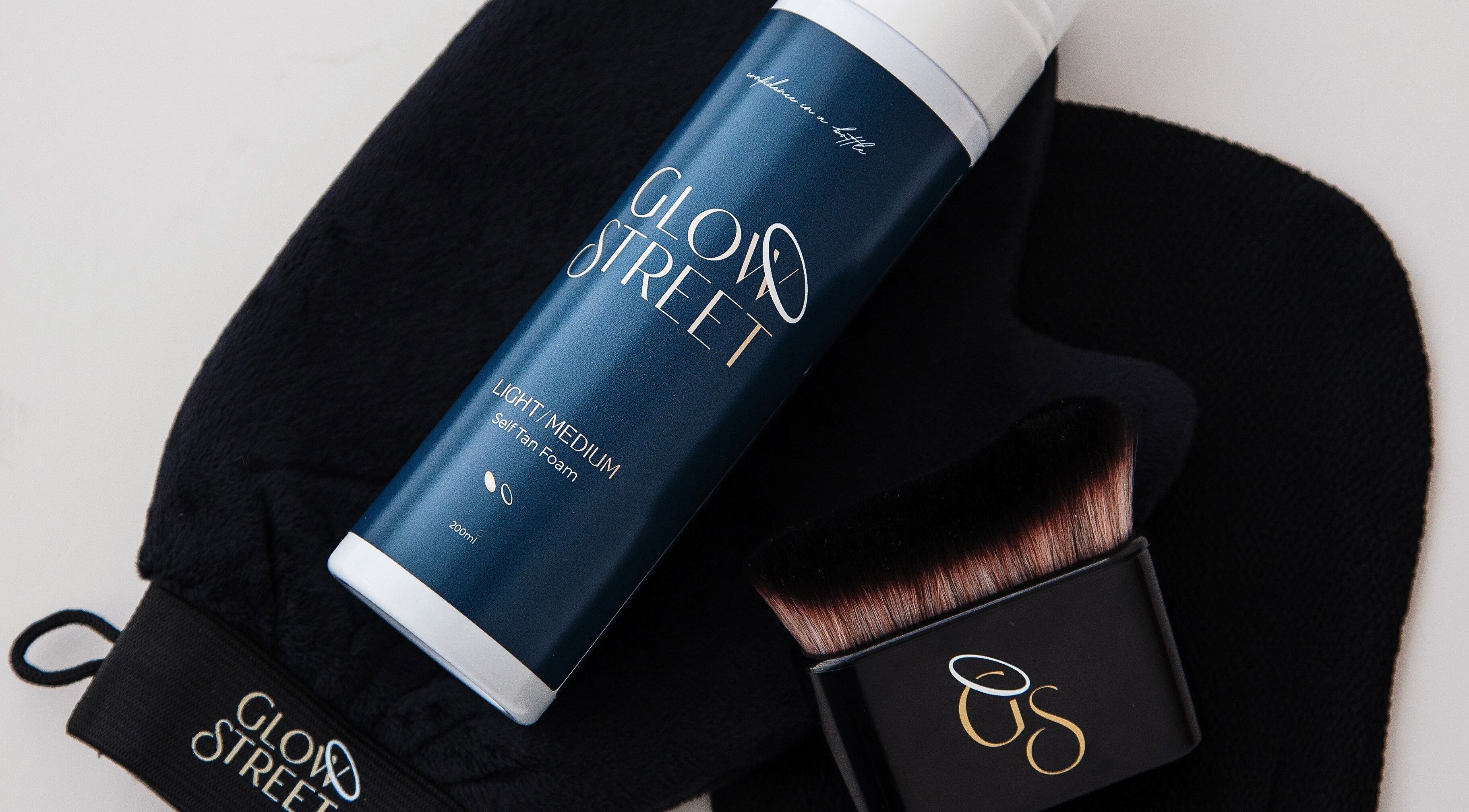 Self-tan products from Inner Glow Beauty, Bulls, Manawatū-whanganui, NZ displayed with a black applicator.