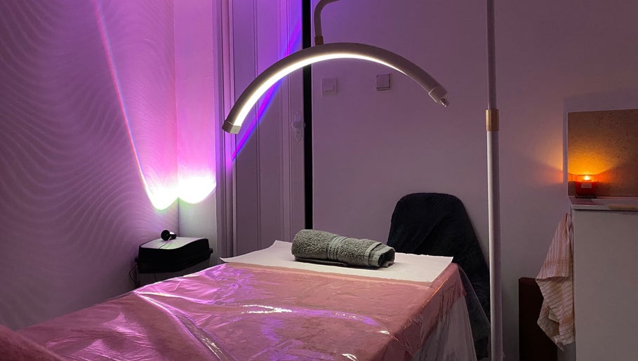 Relaxing treatment room at Embracing Beauty, Iż-żejtun, MT, with ambient lighting and plush massage table.
