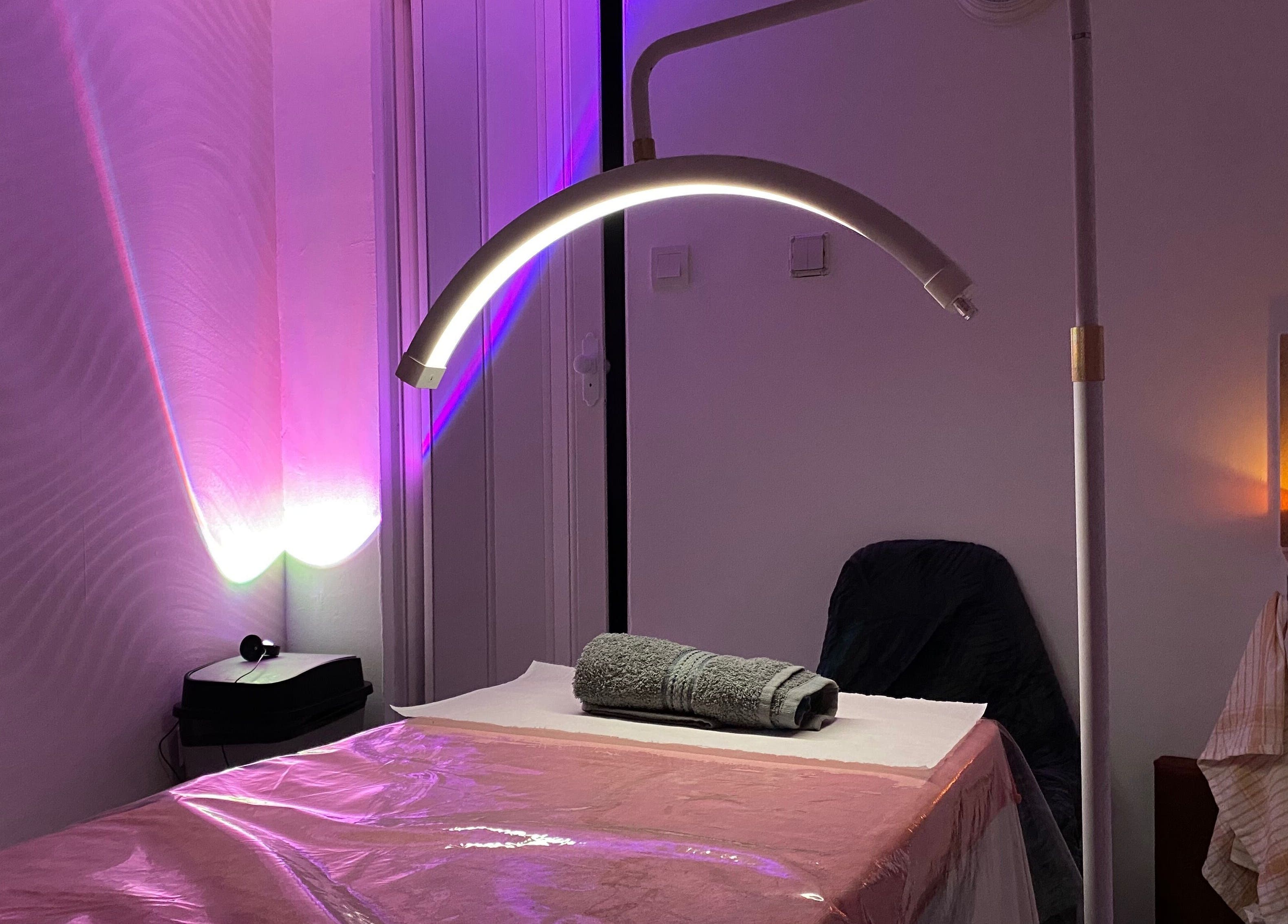 Relaxing spa room at Embracing Beauty, Iż-żejtun, MT with ambient lighting and massage table.