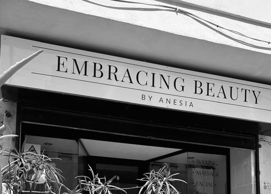 Entrance of Embracing Beauty salon at Iż-Żejtun, MT, showcasing modern sign and inviting decor.