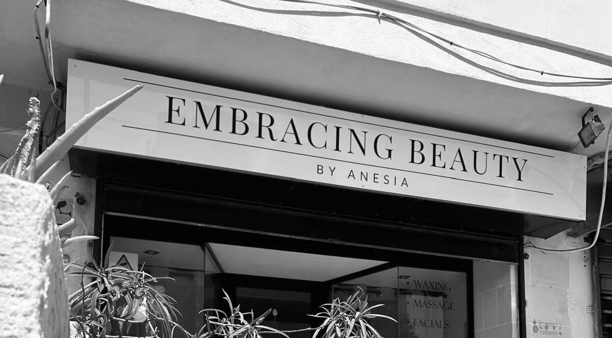 Entrance of Embracing Beauty salon at Iż-Żejtun, MT, showcasing modern sign and inviting decor.