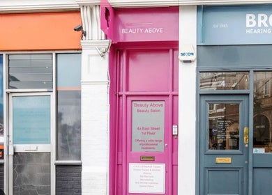 Vibrant pink entrance of Sjthair London, located at Bromley, England, GB, showcasing its unique beauty salon facade.