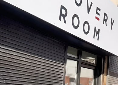 Exterior of The Recovery Room Oldham in Oldham, England, featuring a modern sign above the entrance.