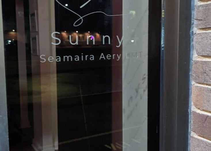 Entrance of Sunny's Massage Therapy in Union City, Tennessee, US, showcasing modern glass door signage.