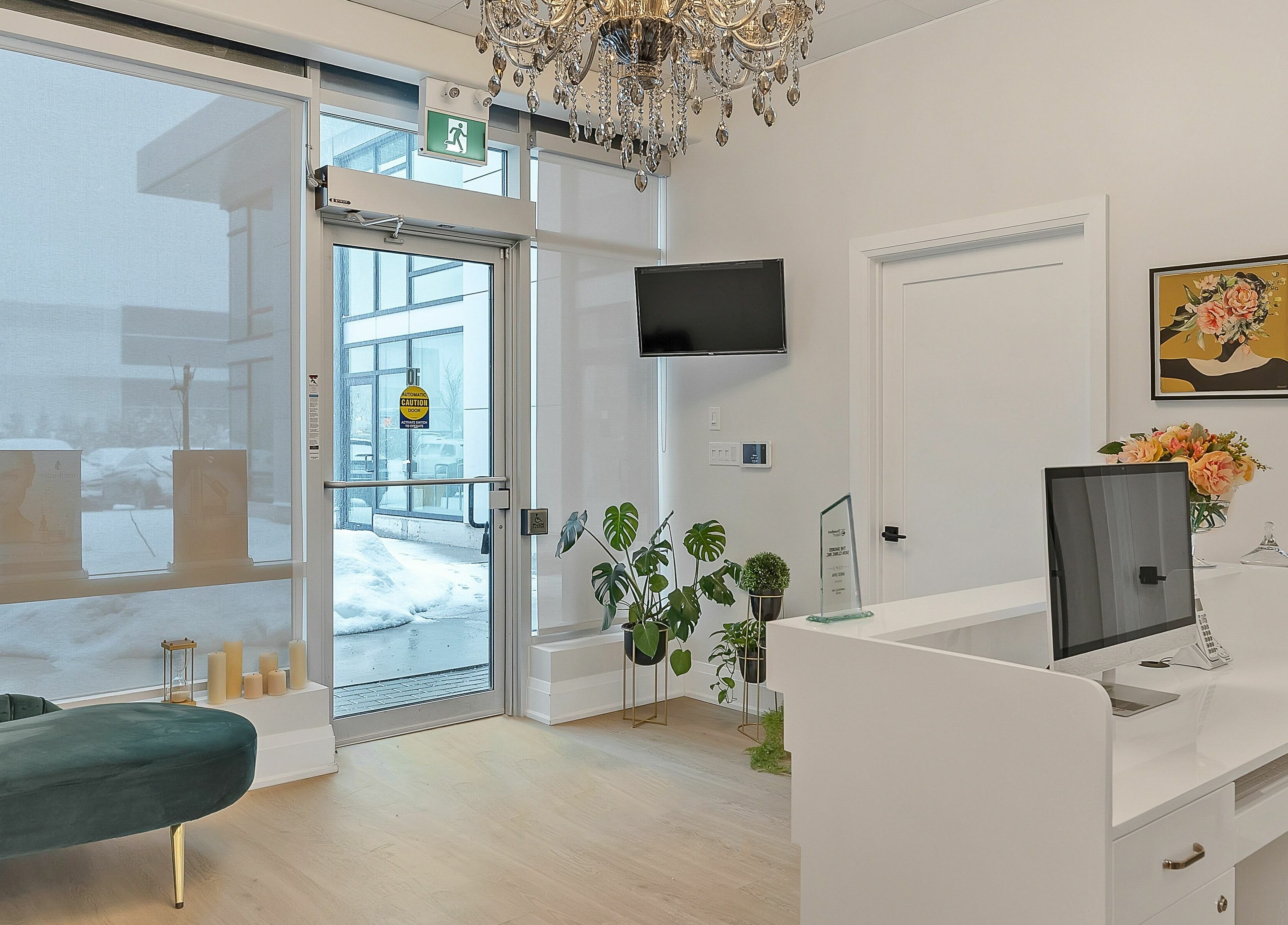 Elegant reception area at TS Skin Clinic and Wellness in Oakville, Ontario, CA with chandelier and seating.
