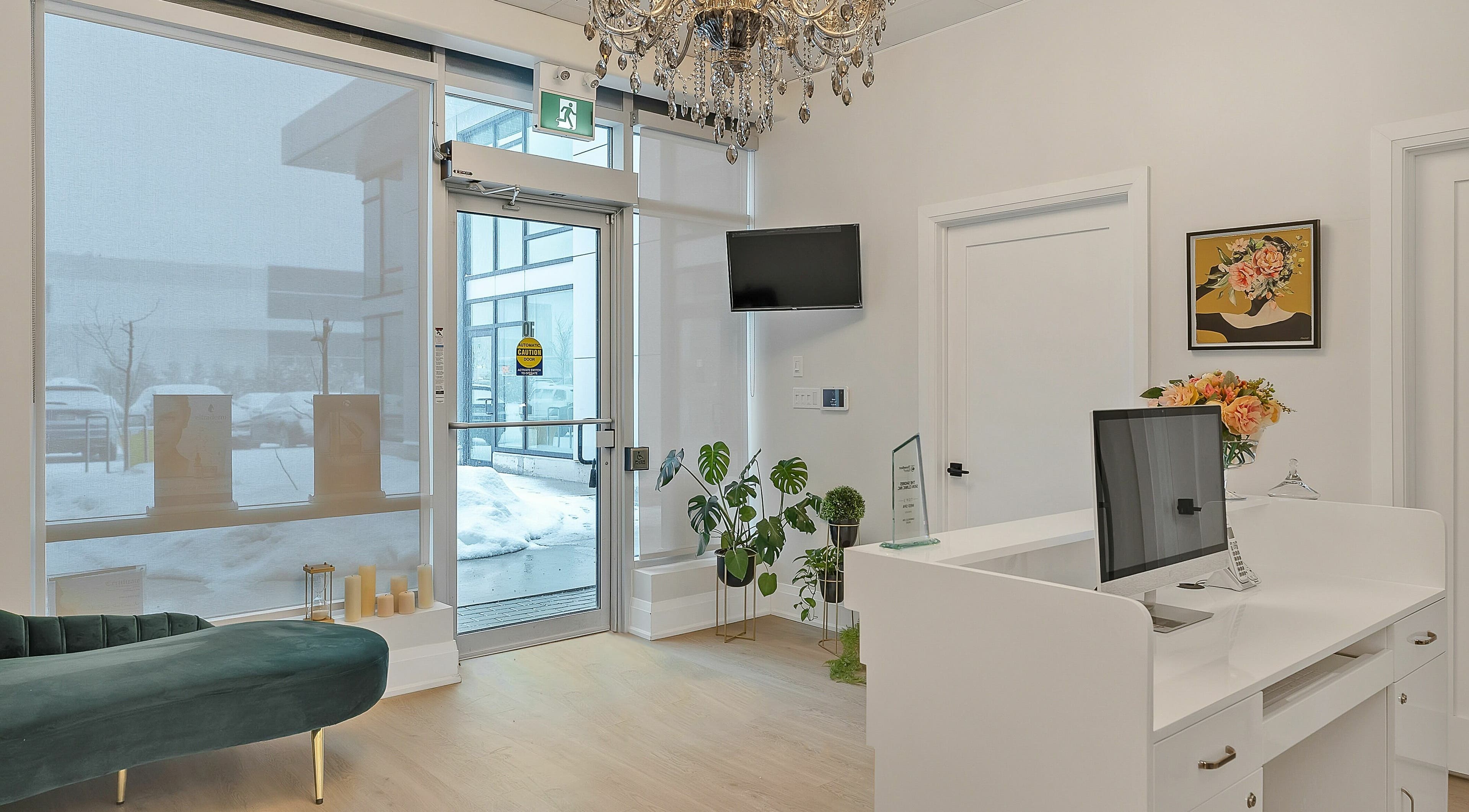 Elegant reception area at TS Skin Clinic and Wellness in Oakville, Ontario, CA with chandelier and seating.