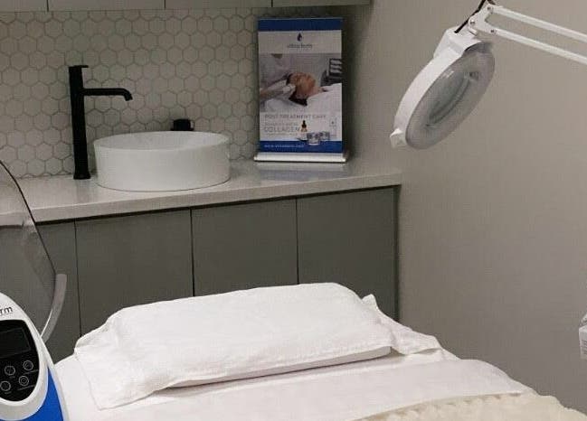 Modern treatment room at TS Skin Clinic and Wellness, Oakville, Ontario, CA with white decor and advanced equipment.