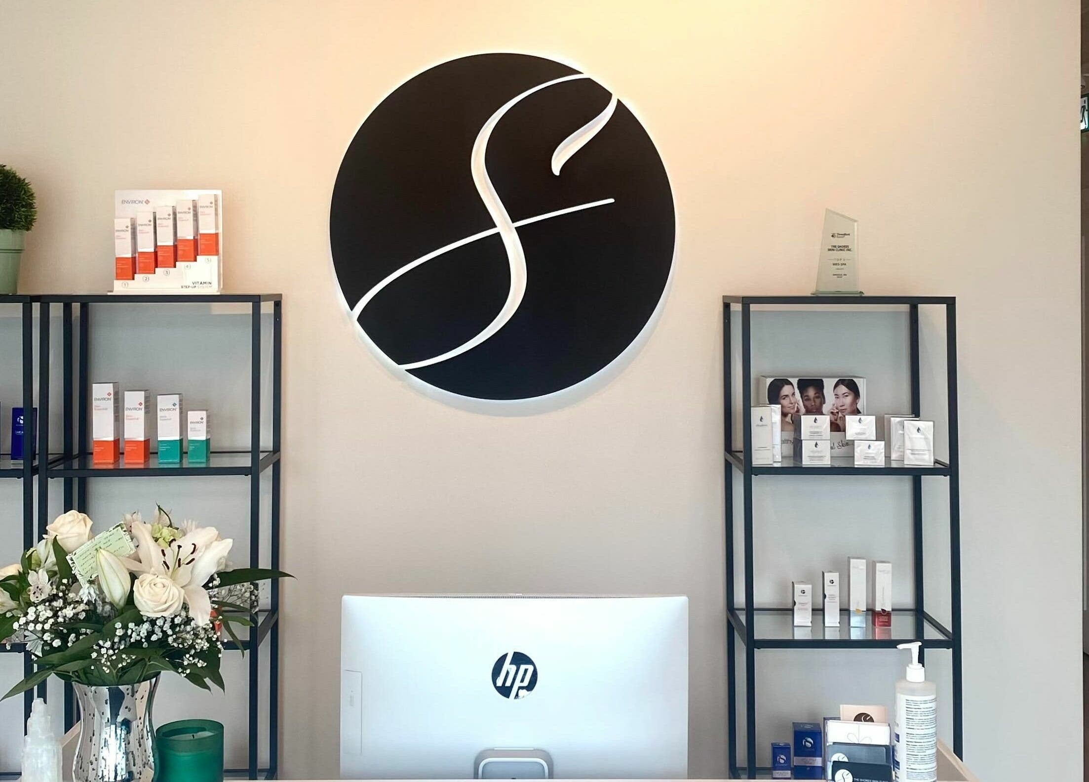 TS Skin Clinic and Wellness reception area with modern decor in Oakville, Ontario, CA, showcasing skincare displays.