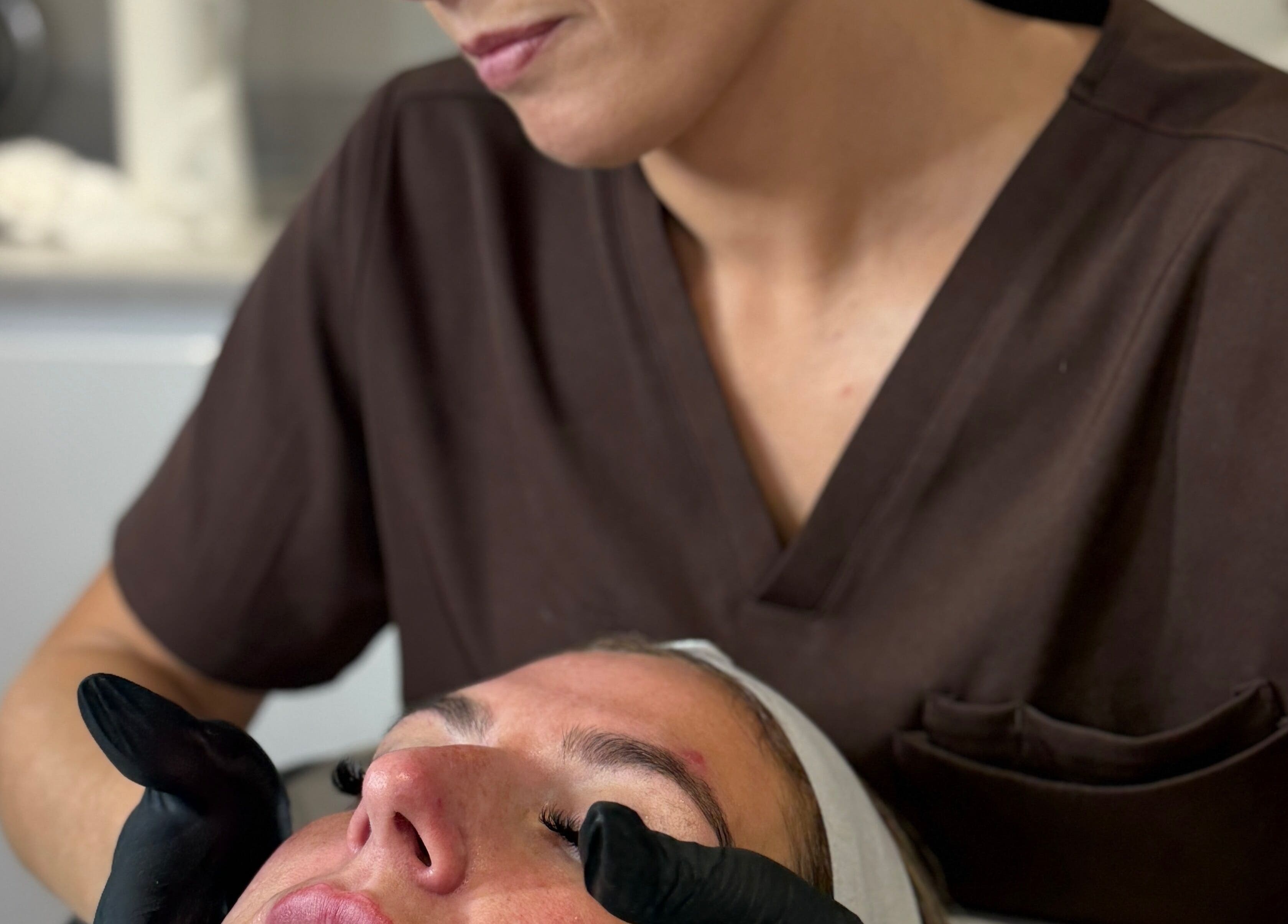 Therapist performing a soothing facial at The Brow Box, Donington le Heath, England, GB.
