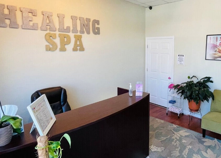 Welcome desk at Healing Spa, Midlothian, Virginia, US, with comfortable seating and decorative plants.