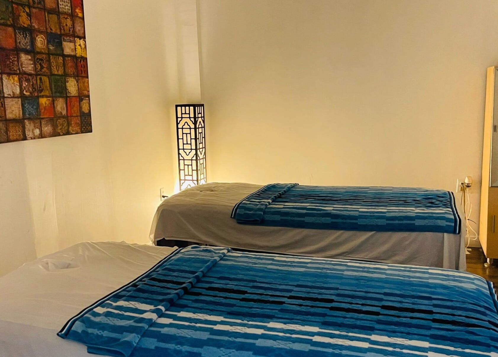 Relaxing therapy room setup at Healing Spa, Midlothian, Virginia, US. Features two massage tables and ambient lighting.