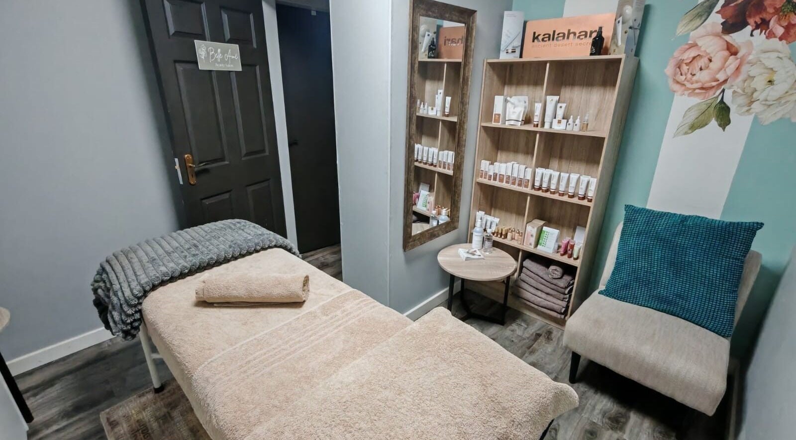 Relaxing treatment room at Belle Amé beauty salon, Centurion, Gauteng, ZA with massage table and product display.