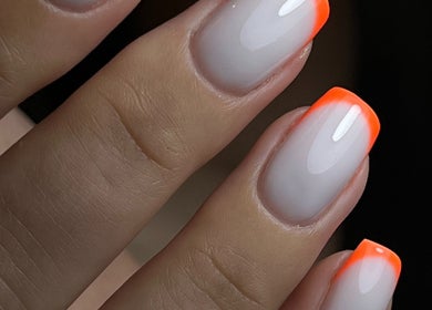 Orange-tipped manicure from Pop Up Well Chiswick in London, England, GB. Elegant nail art with gradient design.