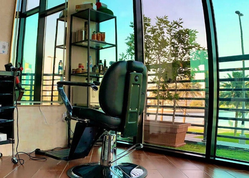 Chic interior at Verve Men's Salon & Spa, الشارقة, إمارة الشارقةّ, AE with a serene garden view.