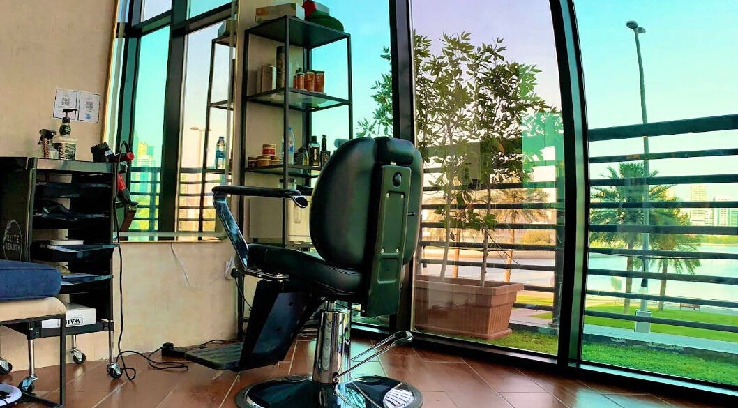 Chic interior at Verve Men's Salon & Spa, الشارقة, إمارة الشارقةّ, AE with a serene garden view.