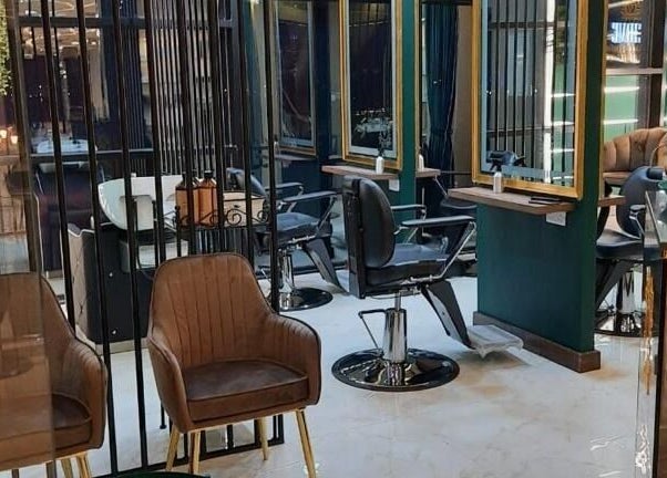 Chic interior of Verve Men's Salon & Spa in الشارقة, إمارة الشارقةّ, AE, featuring modern chairs and mirrors.