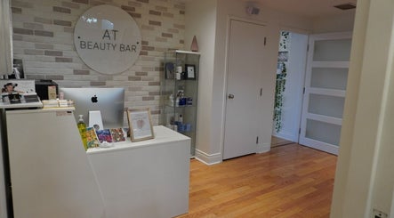 Elegant reception desk at All That Beauty Bar, Ottawa, Ontario, CA with modern decor and product display.