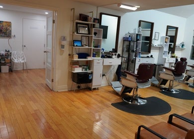 Interior of All That Beauty Bar in Ottawa, Ontario, CA featuring stylish salon chairs and sleek wood floors.