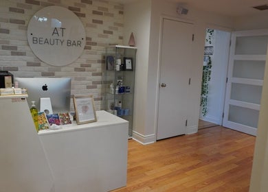 Reception area at All That Beauty Bar, Ottawa, Ontario, CA featuring a modern desk and decor.
