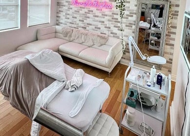 Chic treatment room at All That Beauty Bar, Ottawa, Ontario, CA with comfy couch and professional equipment.