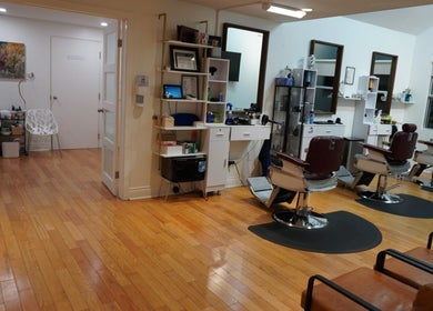Modern salon interior at All That Beauty Bar, Ottawa, Ontario, CA featuring stylish chairs and wooden floors.