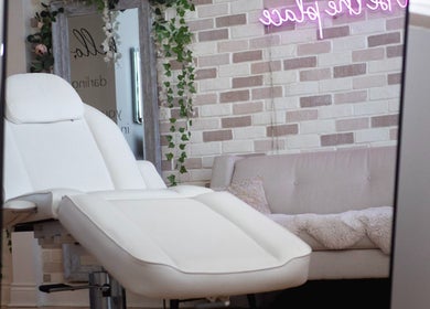 Relaxing treatment room at All That Beauty Bar, Ottawa, Ontario, CA with a plush white chair and cozy ambiance.
