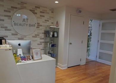 Reception area at All That Beauty Bar in Ottawa, Ontario, CA with modern decor and beauty products.