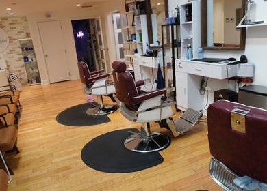 Stylish interior of All That Beauty Bar in Ottawa, Ontario, CA with modern salon chairs and cozy waiting area.