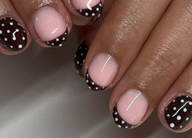 Chic polka dot nail art at Tech Nailz, Cardiff, Wales, GB, showcasing elegant manicure design.