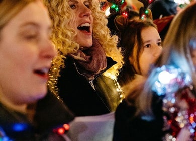 Group of joyful people with holiday lights at SING GENEVA, Genève, Genève, CH.