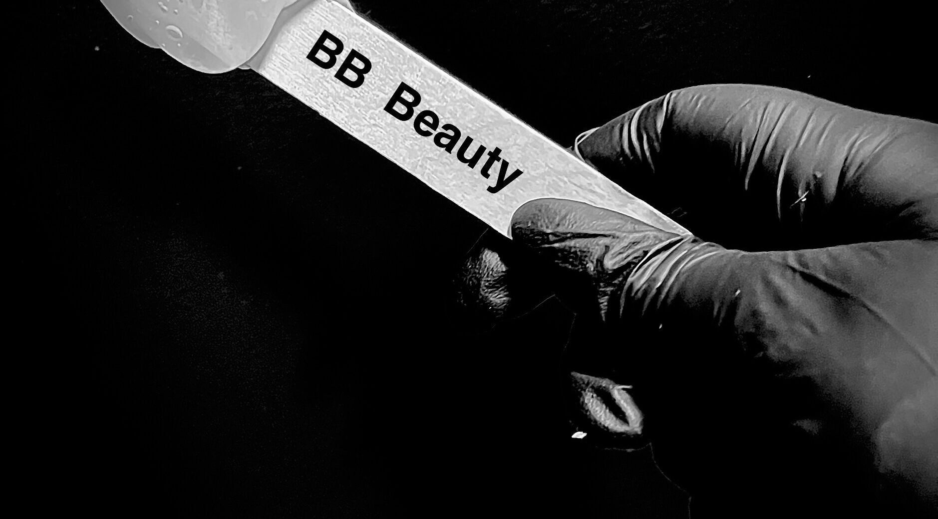 Close-up of gloved hand holding BB Beauty spatula in Davenport, Iowa, US.