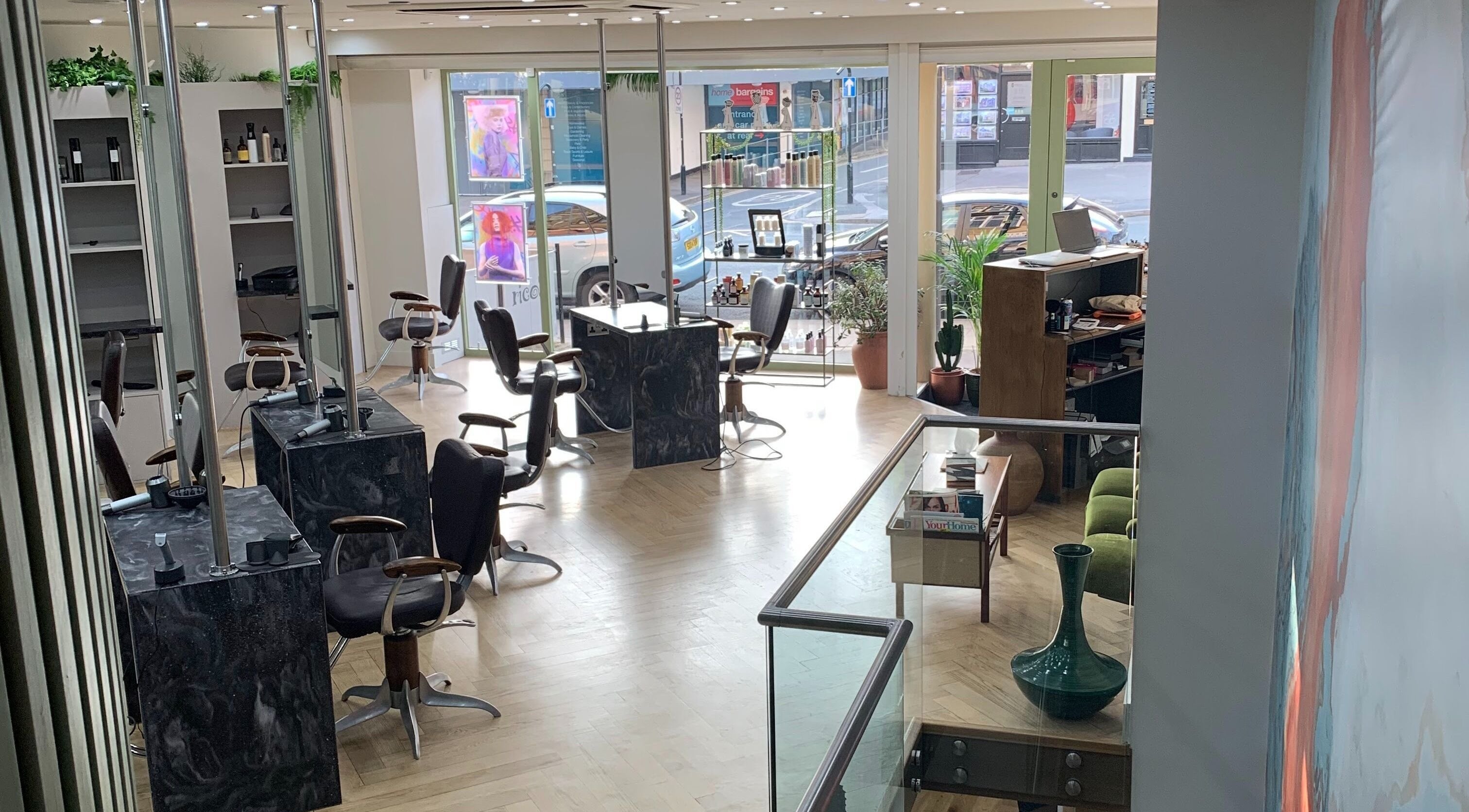 Modern salon interior at Jon Kinsey Hairdressing, Oakwood, England, GB, with stylish chairs and decor.