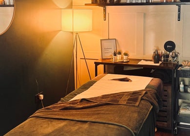 Cozy treatment room at Akemi Spa in Dorchester, England, GB showcasing ambient lighting and wellness setup.