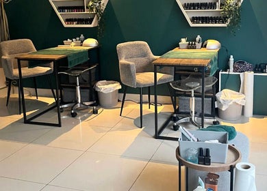 Cozy manicure stations at Akemi Spa, Dorchester, England, GB, featuring rich green walls and plush seating.