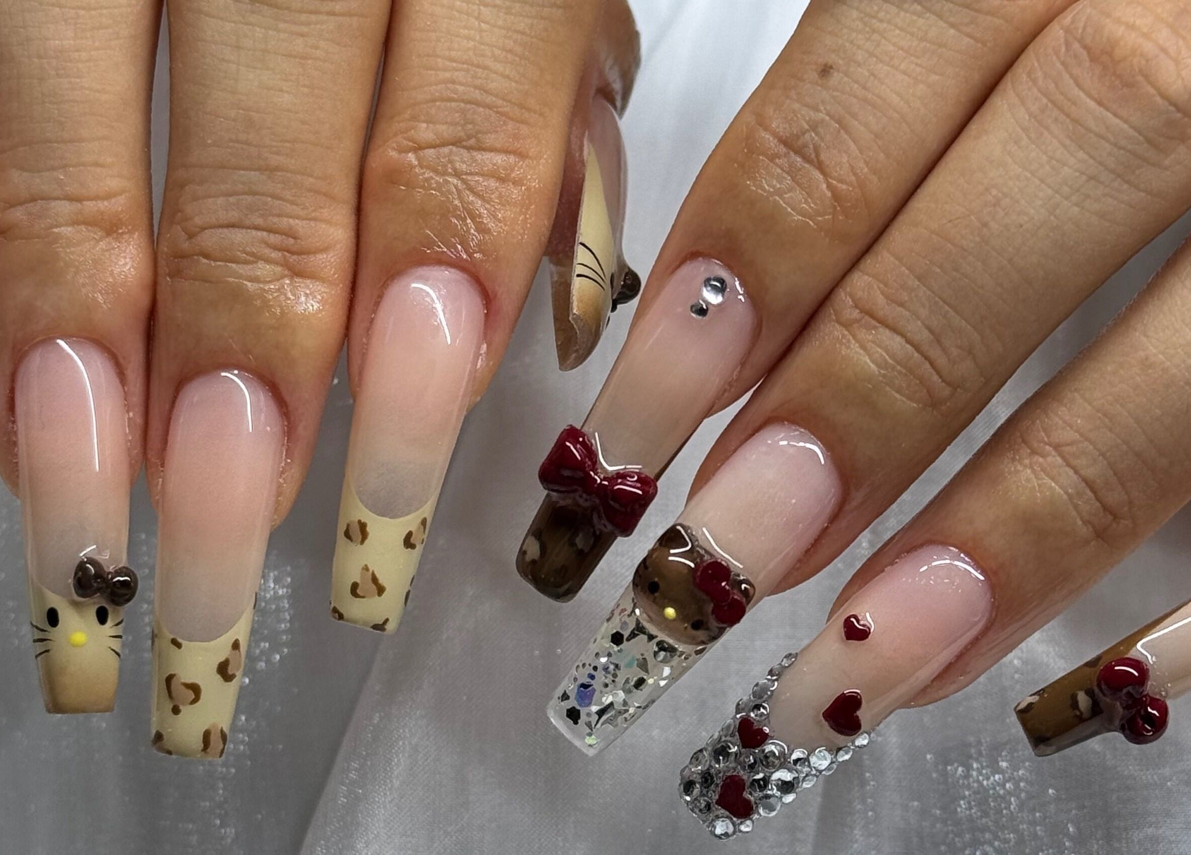 Creative nail art featuring bows and embellishments at Luna Atelier, Burnaby, British Columbia, CA.
