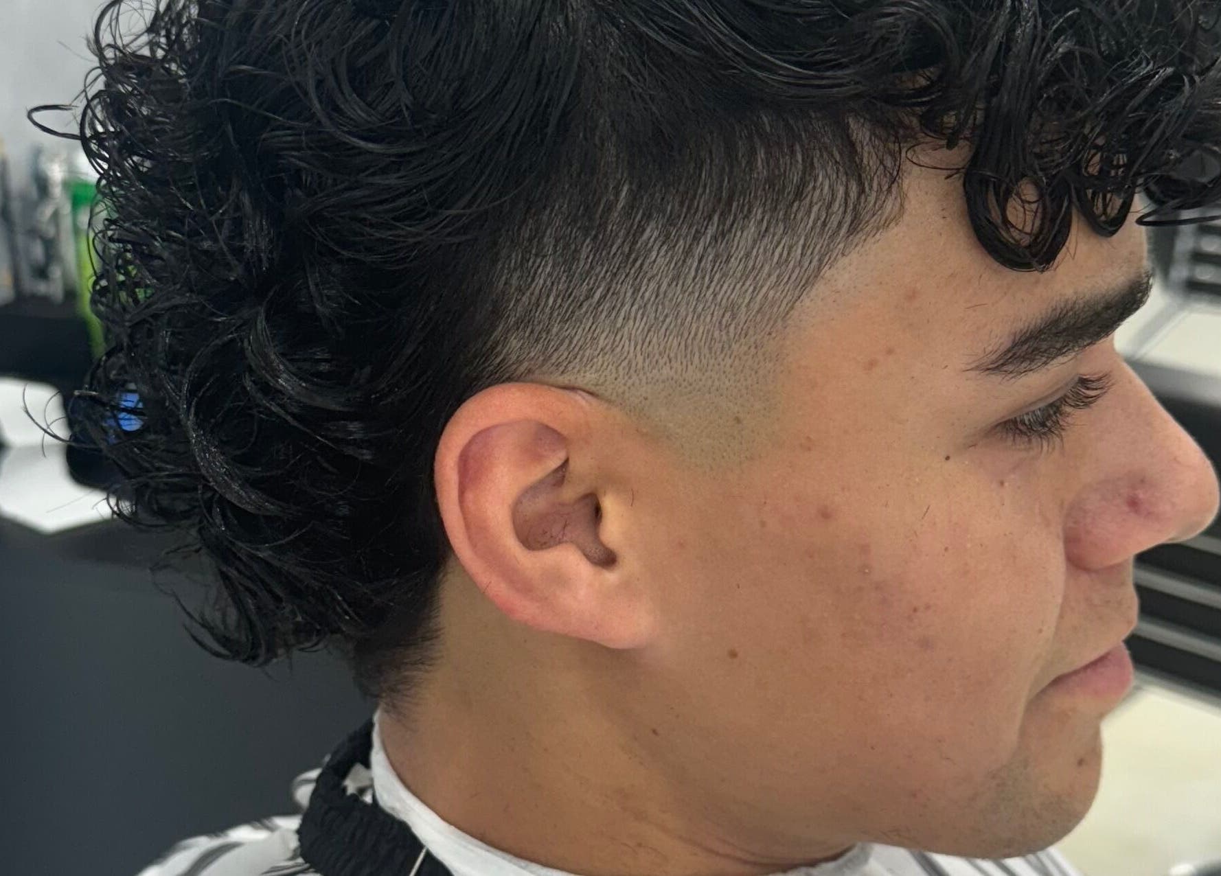 Close-up of a fresh fade haircut with curls at Elivate Studio, Nobleton, Ontario, CA.
