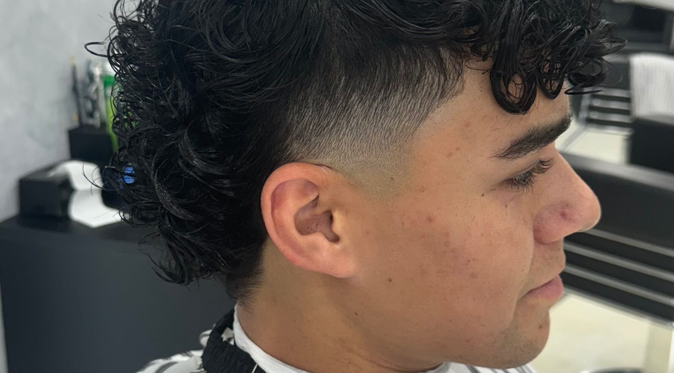 Close-up of a fresh fade haircut with curls at Elivate Studio, Nobleton, Ontario, CA.