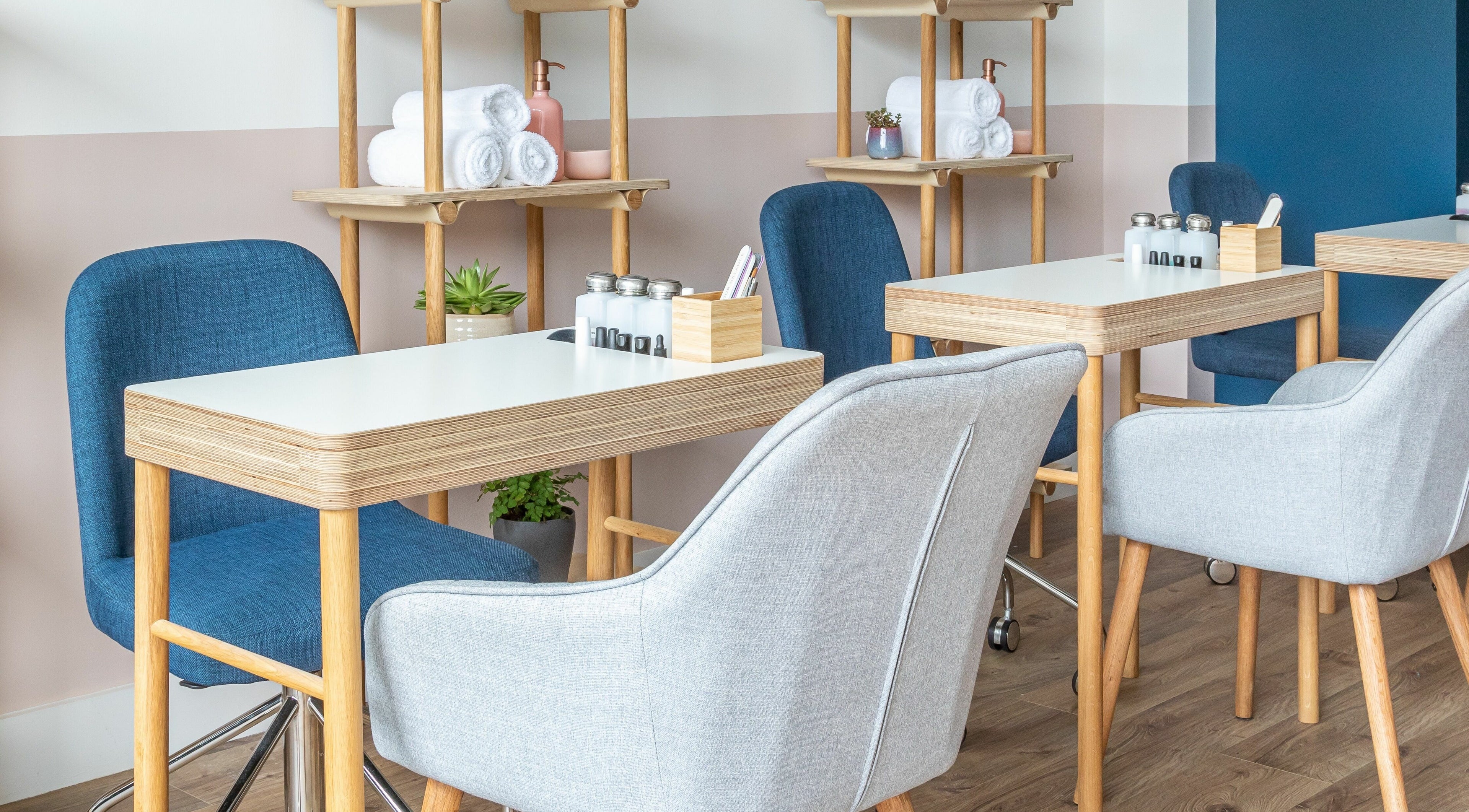 Calm, modern interior of Rose and River, London, England, GB with stylish nail salon tables and chairs.