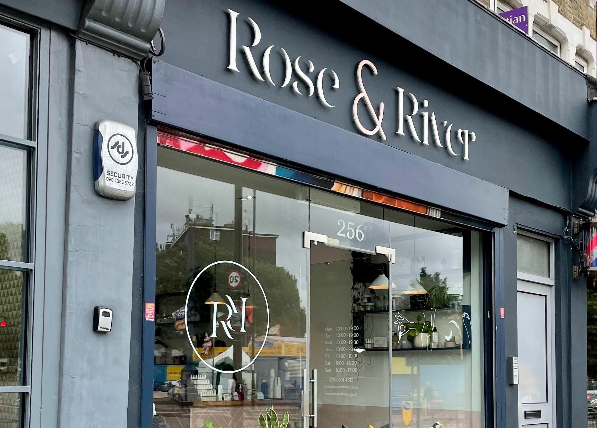 Elegant storefront of Rose and River in London, England, GB featuring glass entrance and modern signage.