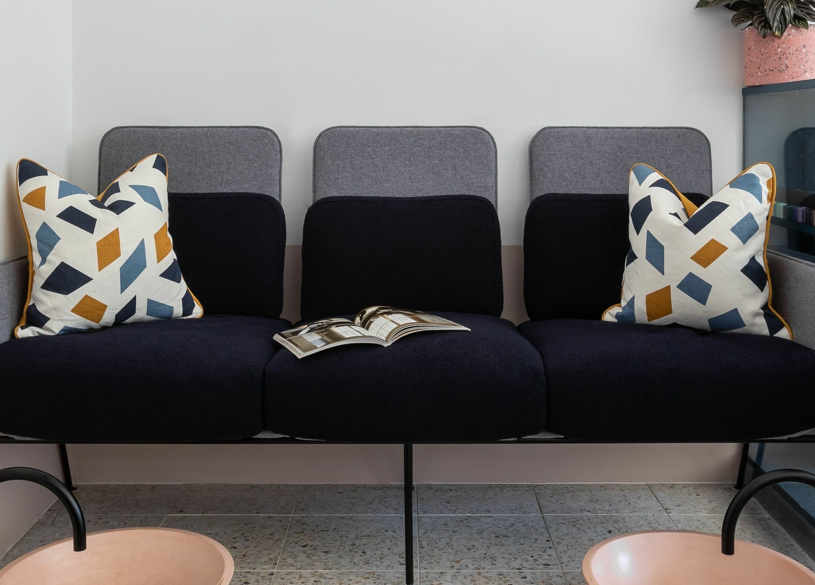 Stylish seating at Rose and River, London, England, GB. Features geometric cushions and sleek decor.