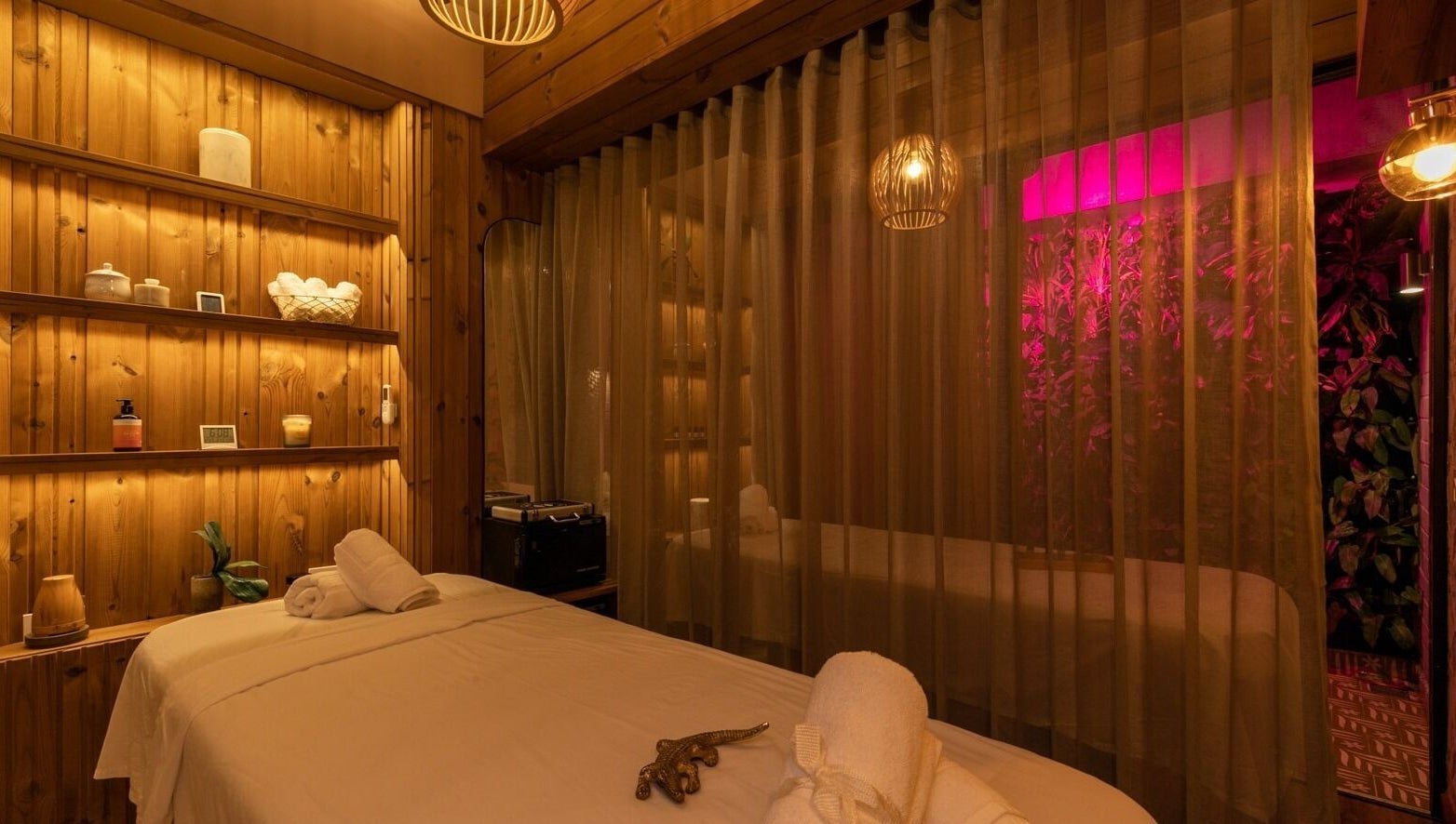 Relaxing treatment room at Celestino Spa, Medellín, Antioquia, CO, with warm lighting and decor.