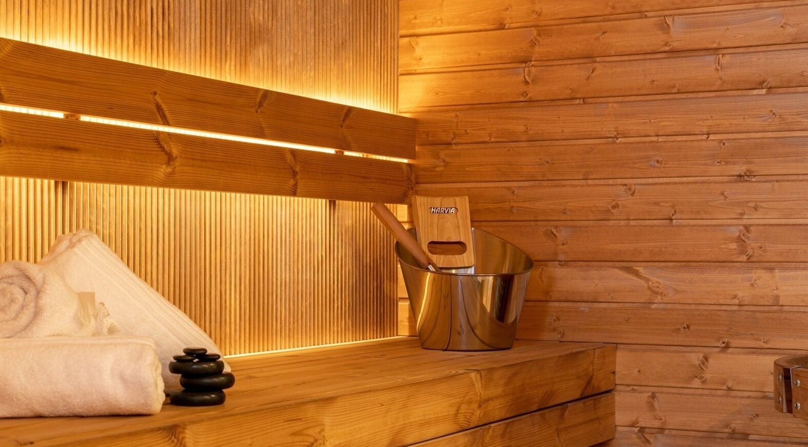 Relaxing sauna interior at Celestino Spa, Medellín, Antioquia, CO, with warm wooden decor and spa essentials.