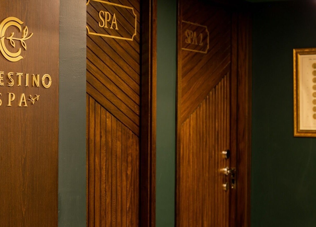 Elegant wooden doors at Celestino Spa, Medellín, Antioquia, CO, showcasing warm ambiance and inviting decor.