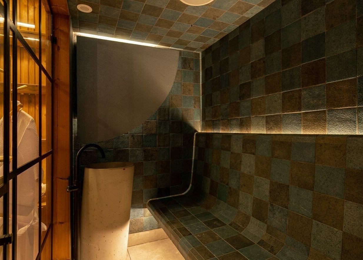 Relaxing sauna at Celestino Spa, Medellín, Antioquia, CO, featuring warm lighting and modern design.