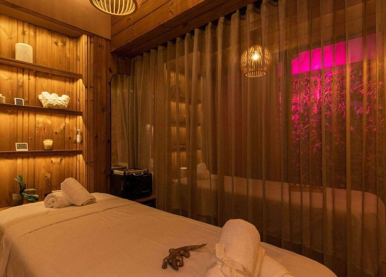 Tranquil treatment room at Celestino Spa, Medellín, Antioquia, CO, featuring soft lighting and cozy ambiance.
