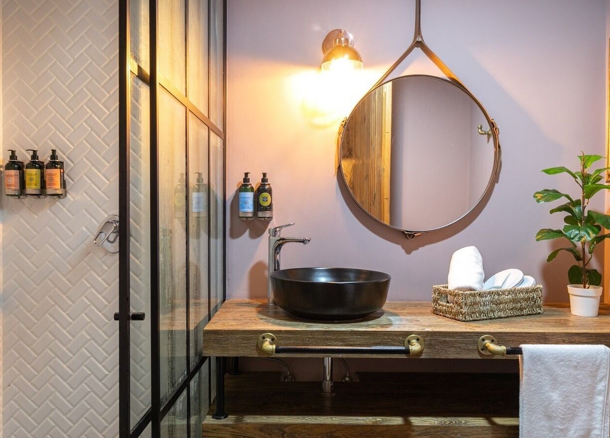 Elegant bathroom vanity at Celestino Spa, Medellín, Antioquia, CO, featuring a stylish mirror and natural decor.