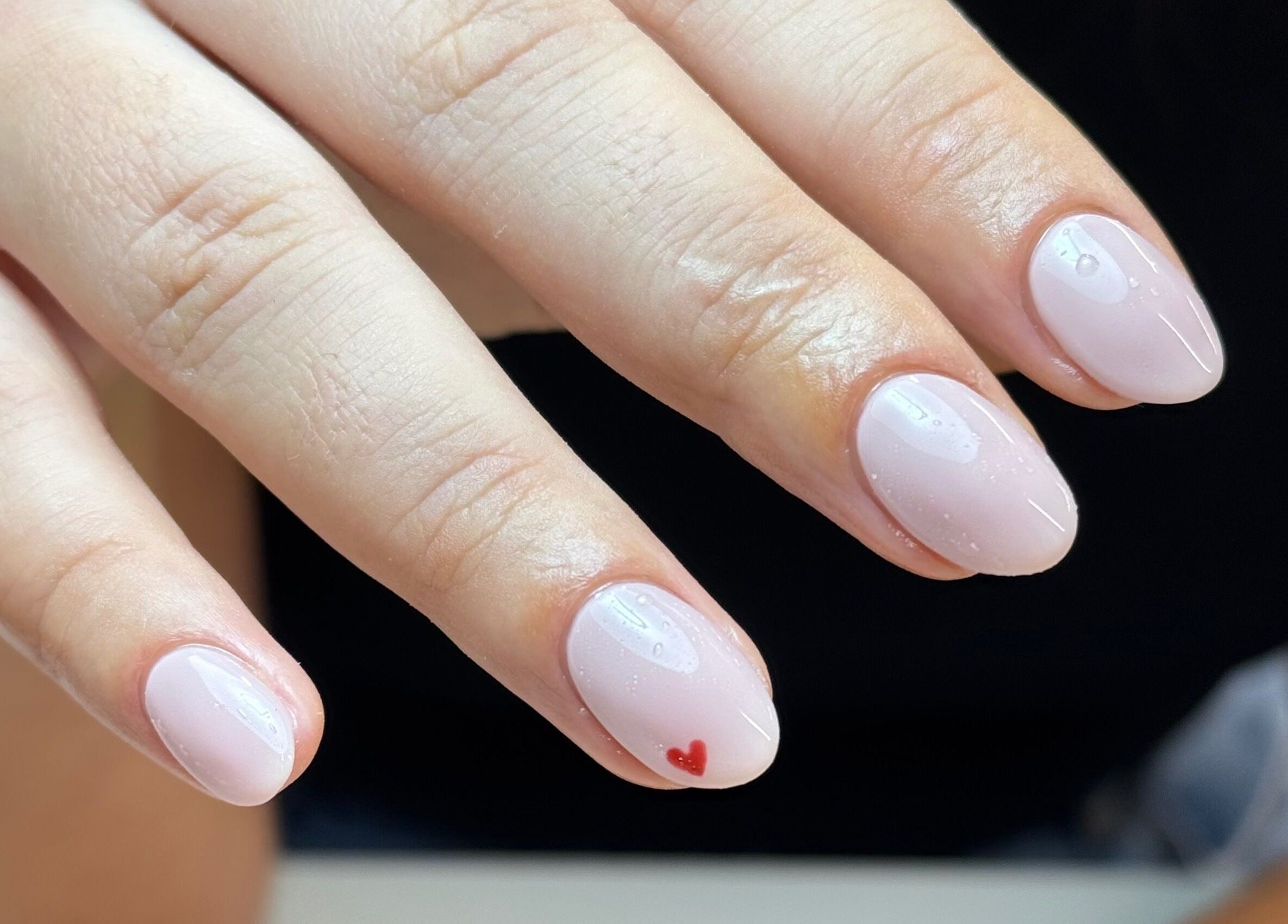 Soft pink manicure with heart design at Morgan Sophie Nails, Colchester, England, GB.